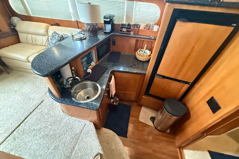 Slide: The Image of Interior of 2000 Carver 396 Motor Yacht with kitchenette and seating area. - 22