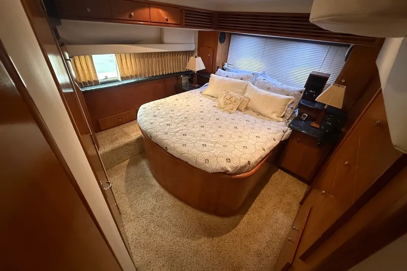 Slide: The Image of Luxurious bedroom interior of 2000 Carver 396 Motor Yacht with cozy bed and elegant decor. - 27