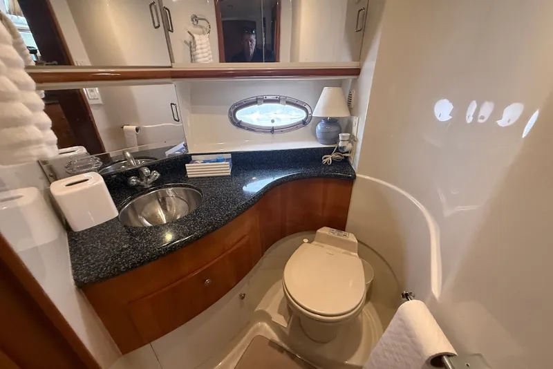 Slide: The Image of Bathroom interior of 2000 Carver 396 Motor Yacht with sink, toilet, and porthole window. - 25