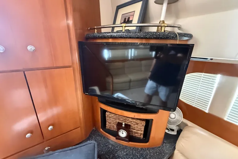 Slide: The Image of Interior of 2000 Carver 396 Motor Yacht with TV and wooden cabinetry. - 20