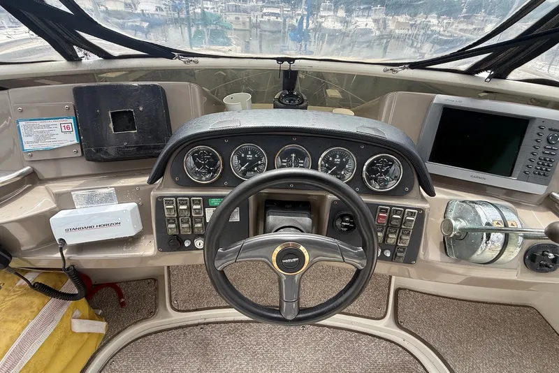 Slide: The Image of Control panel of a 2000 Carver 396 Motor Yacht with steering wheel and navigation instruments. - 16