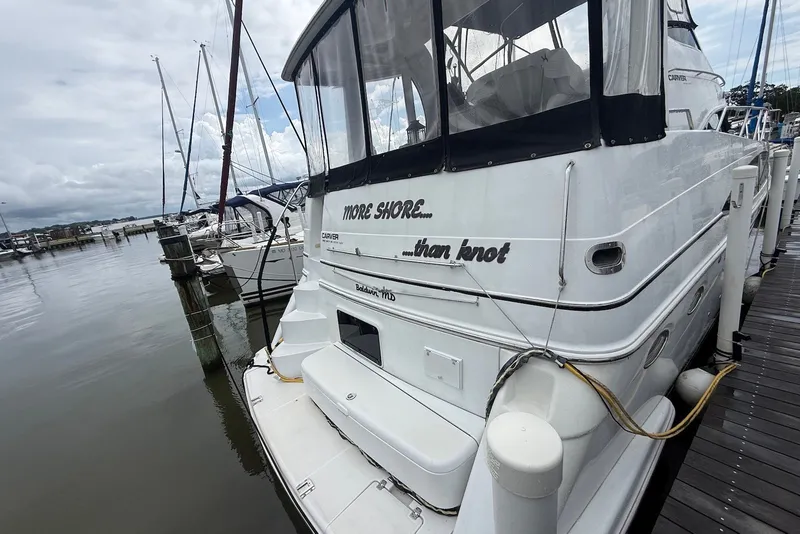 Slide: The Image of Carver 396 Motor Yacht 2000 docked at marina, featuring "More Shore...than Knot" text. - 2