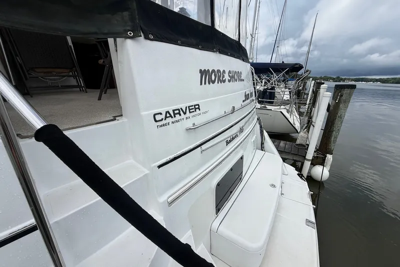 Slide: The Image of Carver 396 Motor Yacht 2000 docked, showcasing sleek design and spacious deck. - 3
