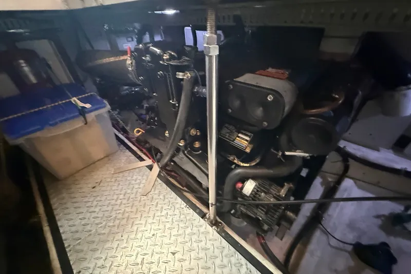 Slide: The Image of Engine room of a 2000 Carver 396 Motor Yacht with visible machinery and storage. - 32