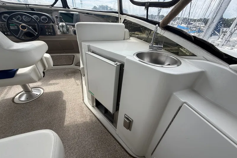 Slide: The Image of Interior of 2000 Carver 396 Motor Yacht with helm, sink, and seating area. - 11
