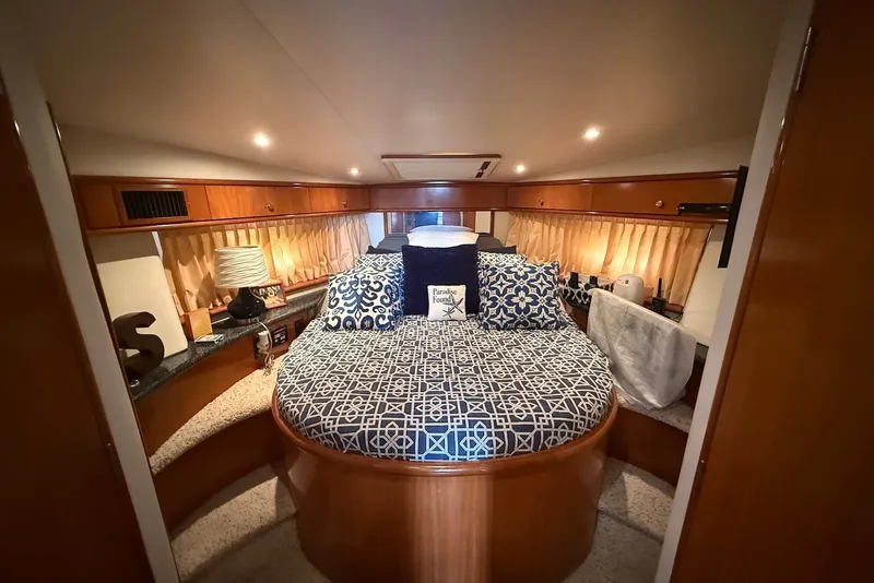 Slide: The Image of Luxurious interior of 2000 Carver 396 Motor Yacht with elegant bedding and ambient lighting. - 23