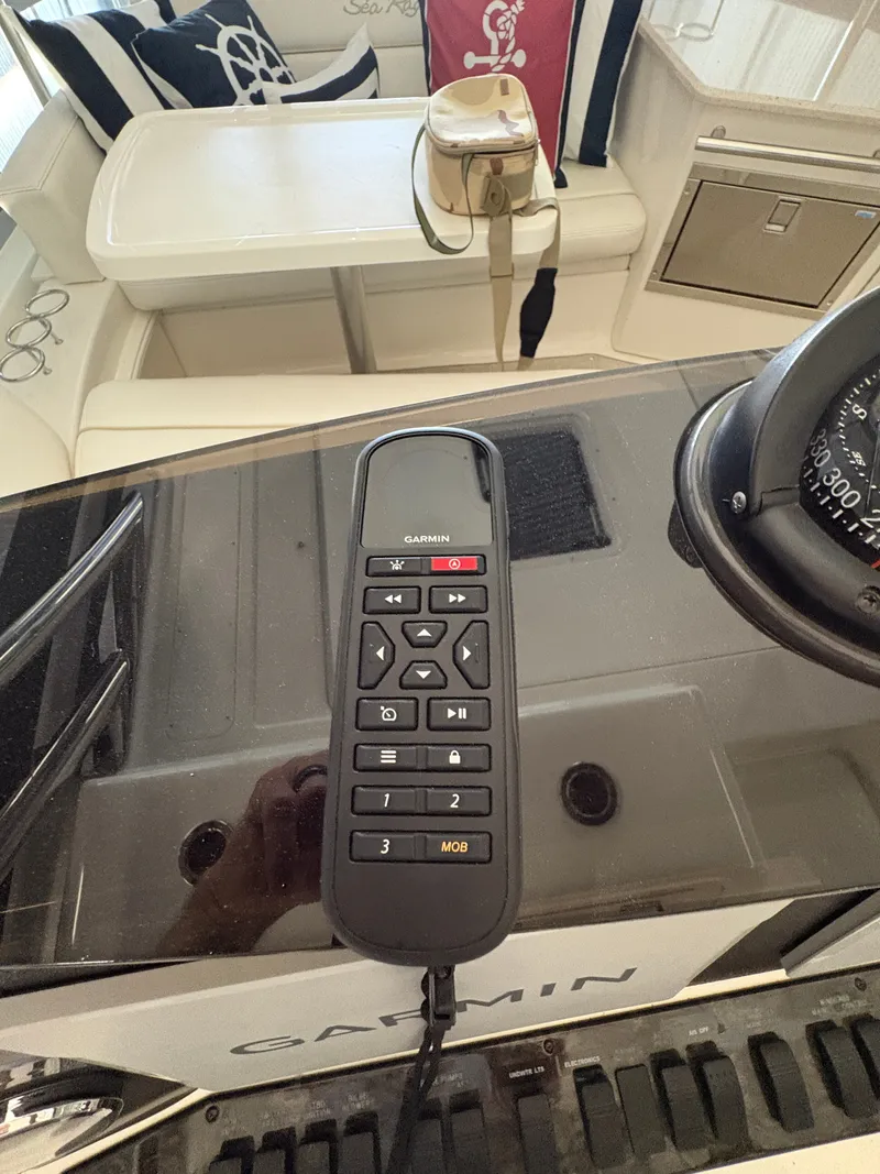 Slide: The Image of Garmin remote control on the helm of a 2008 Sea Ray 47 Sedan Bridge. - 7