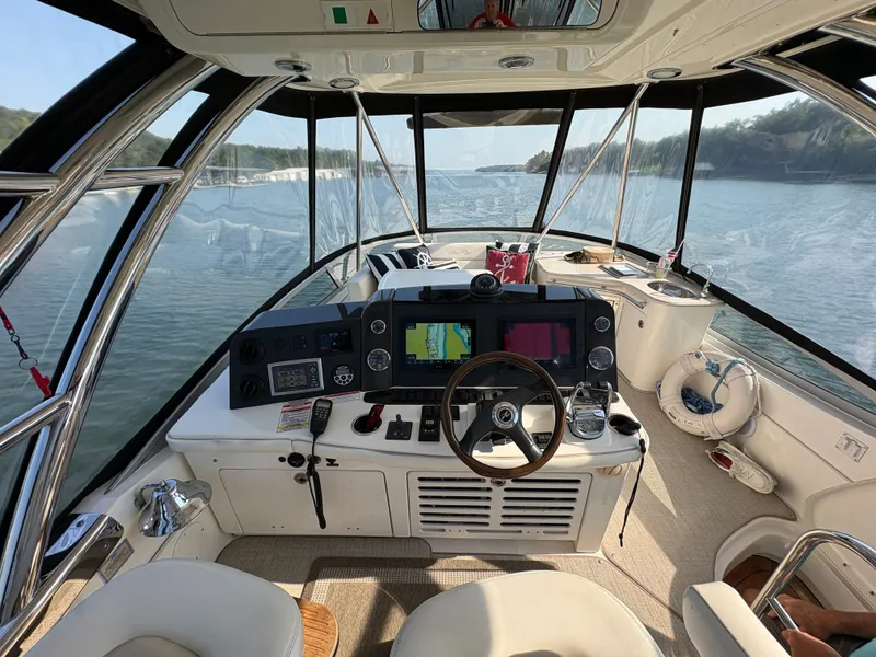 Slide: The Image of The image shows the helm of a 2008 Sea Ray 47 Sedan Bridge with modern navigation systems. - 26
