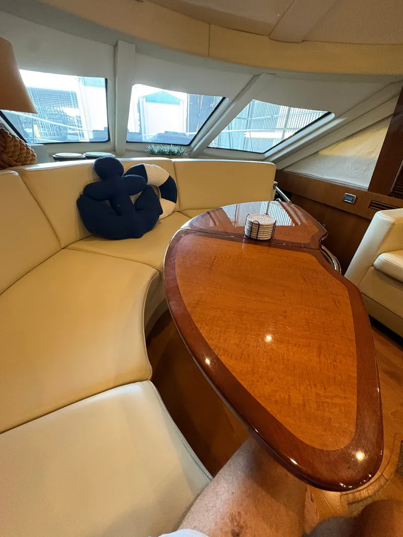 Slide: The Image of Interior of a 2008 Sea Ray 47 Sedan Bridge with elegant wooden table and beige upholstery. - 42