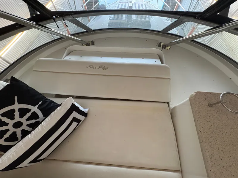 Slide: The Image of Interior view of a 2008 Sea Ray 47 Sedan Bridge with beige upholstery and a decorative pillow. - 10