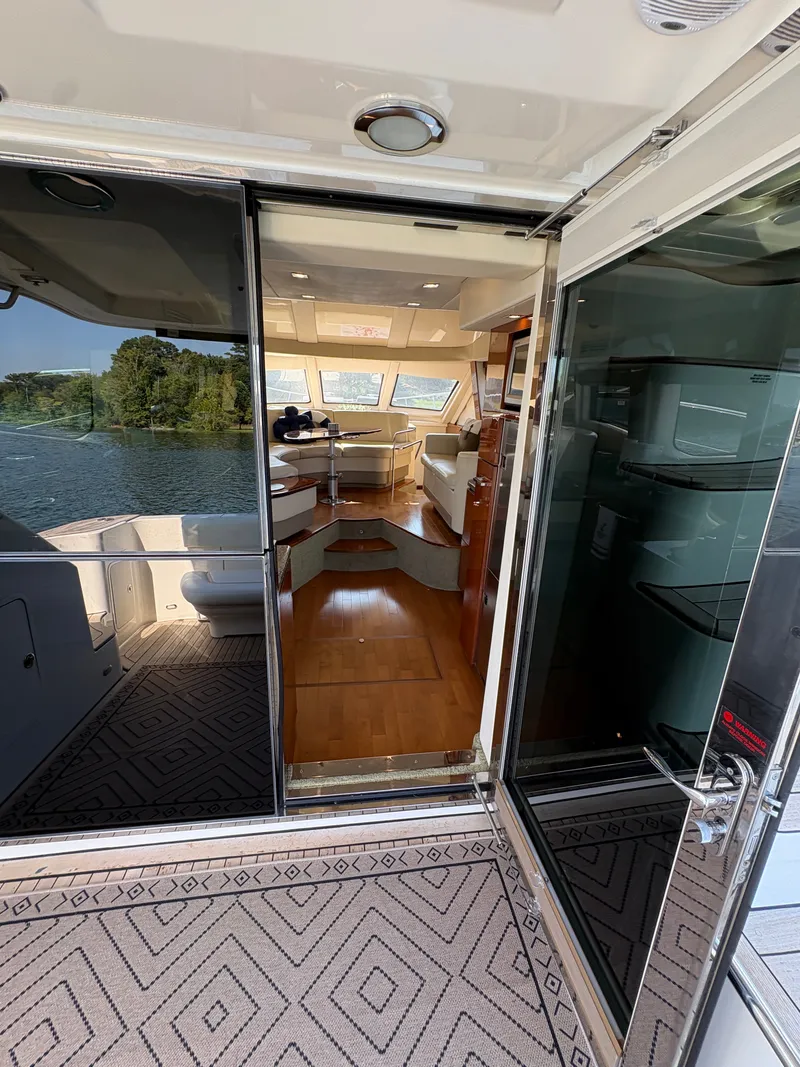 Slide: The Image of View into the cabin of a 2008 Sea Ray 47 Sedan Bridge with wood flooring and large windows. - 32