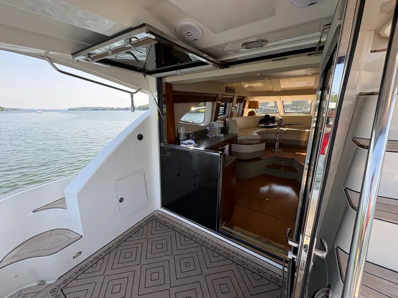 Slide: The Image of View from the deck into the interior of a 2008 Sea Ray 47 Sedan Bridge with elegant furnishings. - 47