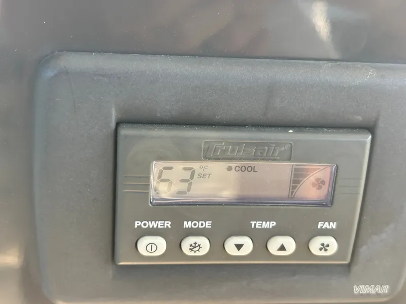 Slide: The Image of An air conditioning control panel with temperature display and control buttons. - 21