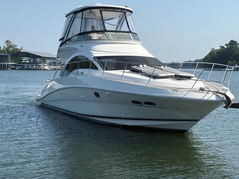 Slide: The Image of The 2008 Sea Ray 47 Sedan Bridge cruises on calm waters, featuring a covered helm station. - 1