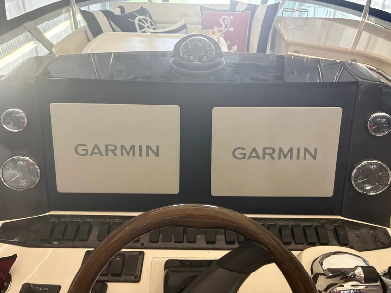 Slide: The Image of The image shows the helm of a 2008 Sea Ray 47 Sedan Bridge with two Garmin screens. - 6