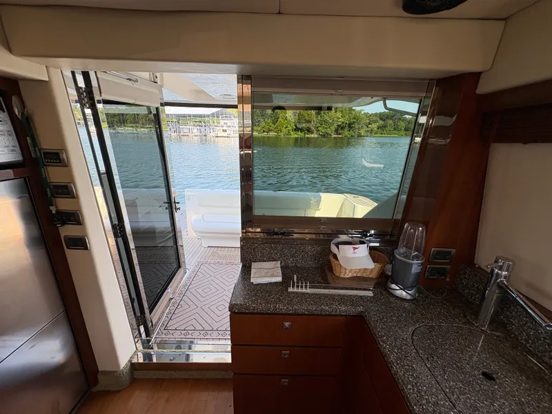 Slide: The Image of Interior of a 2008 Sea Ray 47 Sedan Bridge with a view of the water. - 46