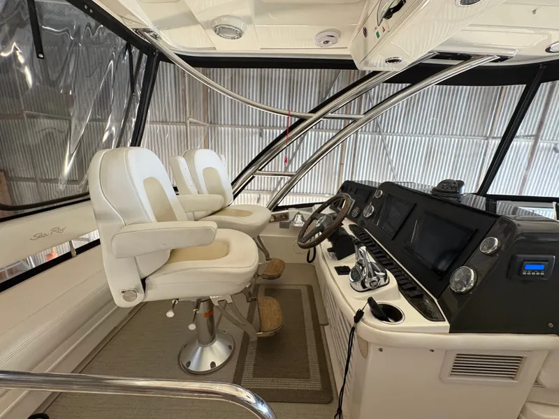 Slide: The Image of Interior of the 2008 Sea Ray 47 Sedan Bridge with two white captain's chairs and a modern helm. - 17