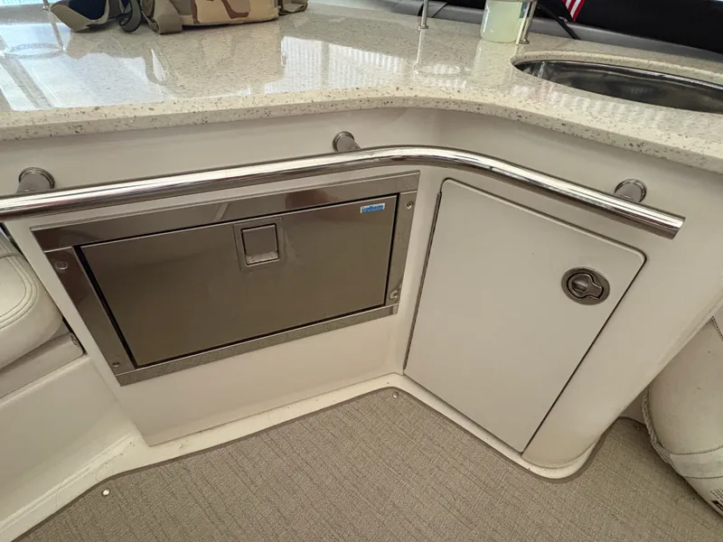 Slide: The Image of The 2008 Sea Ray 47 Sedan Bridge galley features a countertop, sink, and storage space. - 11