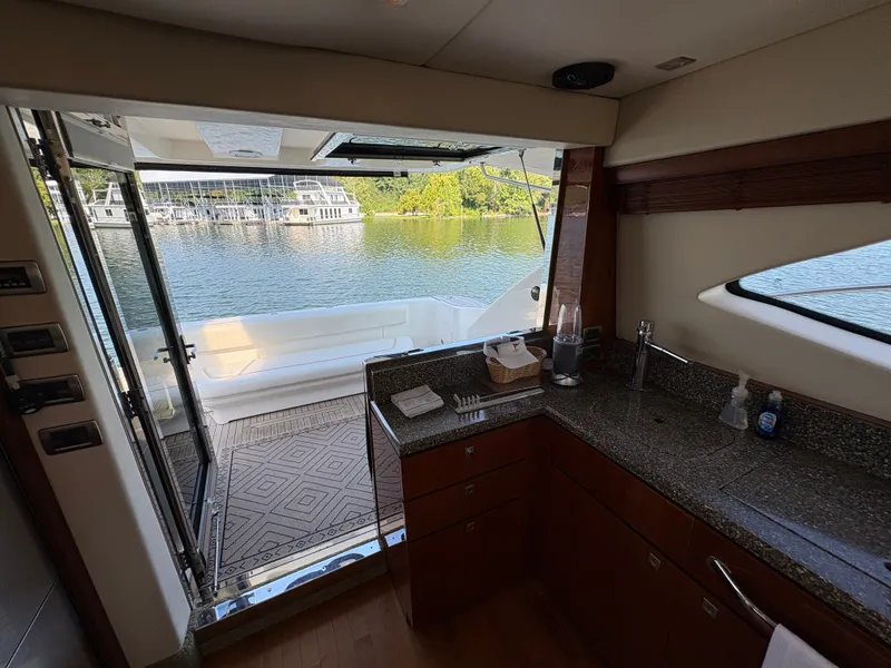 Slide: The Image of Interior view of a 2008 Sea Ray 47 Sedan Bridge overlooking the water. - 49