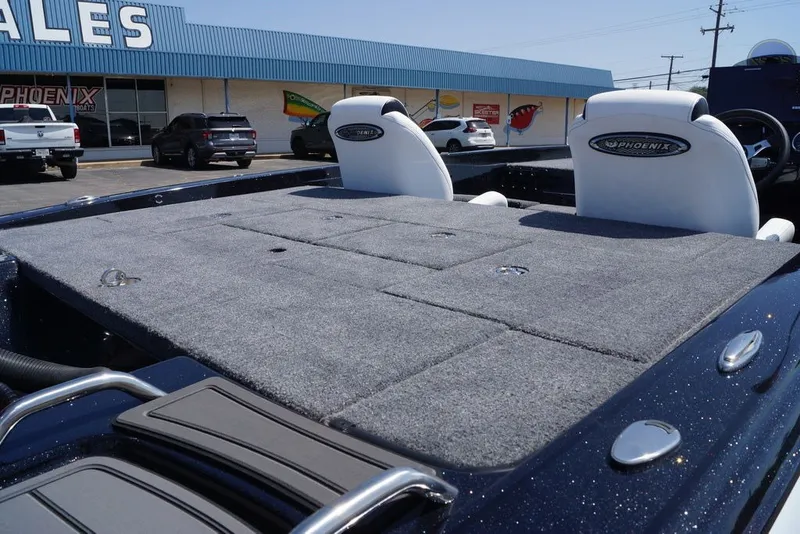 Slide: The Image of 2027 Phoenix 720 ZXL boat with carpeted deck and branded seats at dealership. - 12
