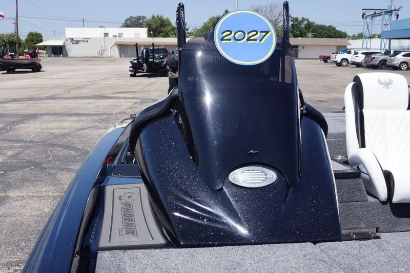 Slide: The Image of 2027 Phoenix 720 ZXL boat with sleek design and modern features in a parking lot. - 10