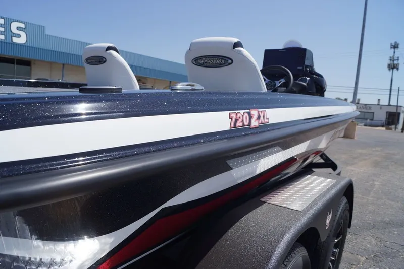 Slide: The Image of 2027 Phoenix 720 ZXL boat, sleek design, parked outdoors, close-up view. - 4