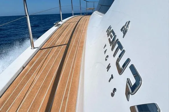 Slide: The Image of Aventura 38 Motor Yacht 2026 cruising on open sea with sleek wooden deck. - 18