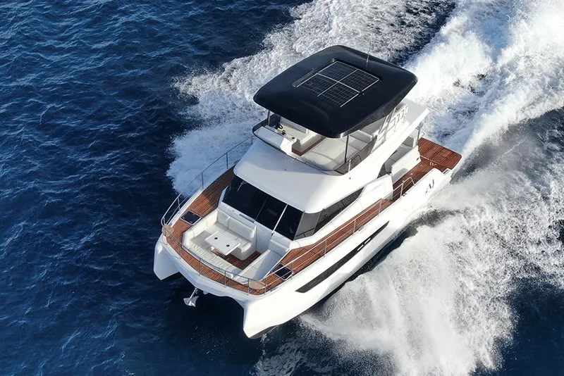 Slide: The Image of Aventura 38 Motor Yacht 2026 cruising on open water, showcasing sleek design and solar panels. - 1