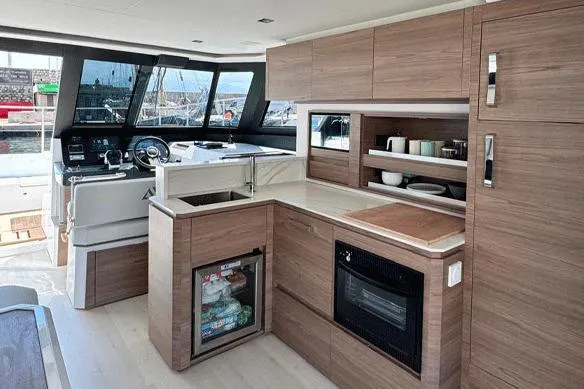Slide: The Image of Modern kitchen interior of 2026 Aventura 38 Motor Yacht with wood cabinetry and appliances. - 4