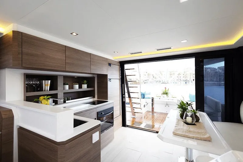 Slide: The Image of Luxurious interior of 2026 Aventura 38 Motor Yacht with modern kitchen and open deck view. - 14