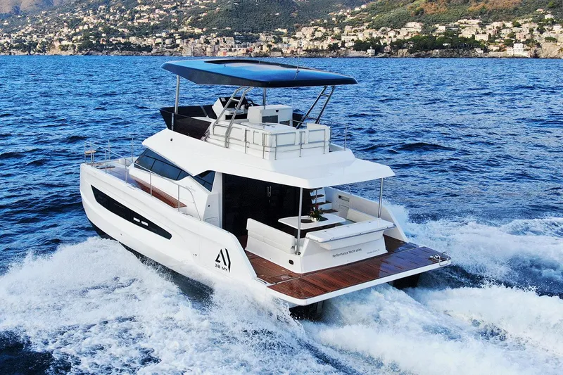 The Image of 2026 Aventura 38 Motor Yacht cruising on blue ocean near scenic coastline. - 2