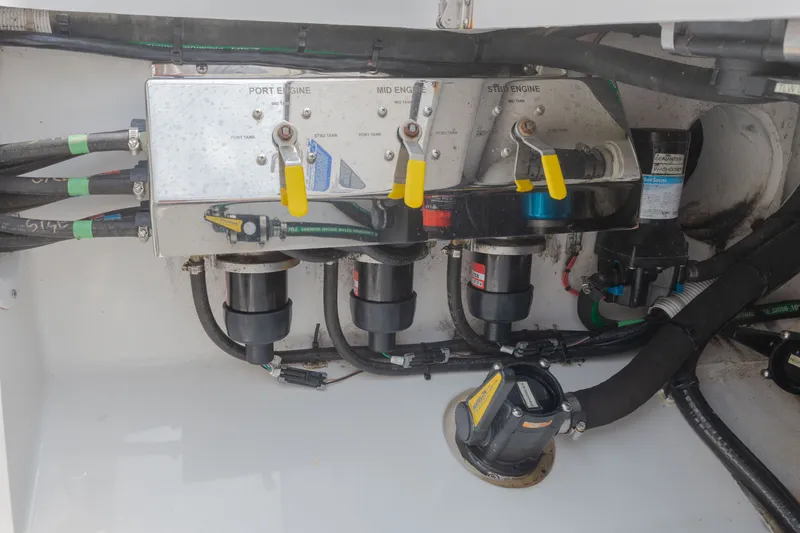 Slide: The Image of A technical area with valves and hoses inside a boat. - 49