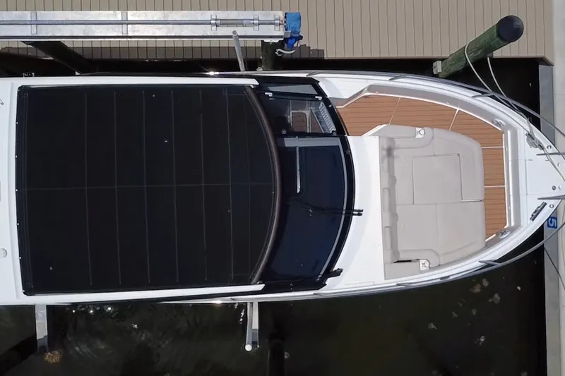 Slide: The Image of Top view of 2024 Skamander 100 Sorrento boat docked, featuring sleek design and spacious seating. - 17