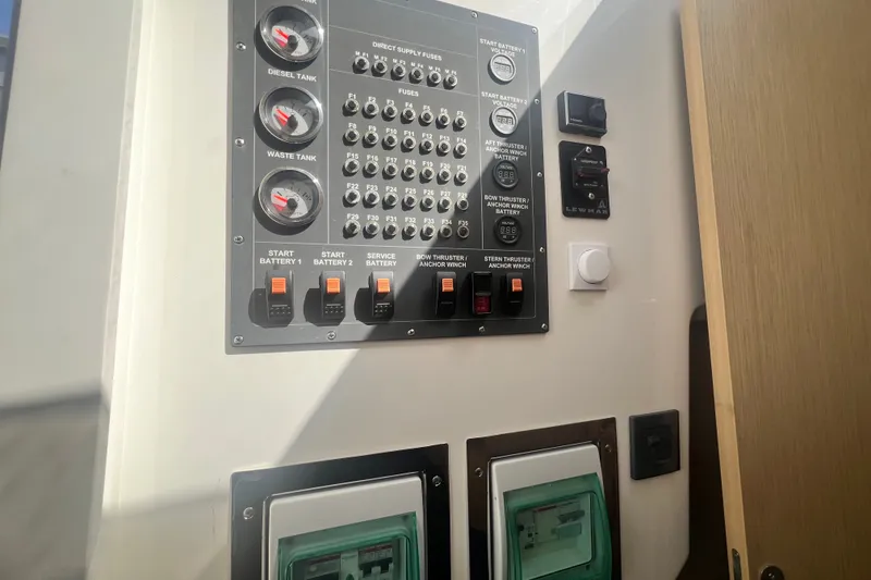 Slide: The Image of Control panel of a 2024 Skamander 100 Sorrento boat, featuring gauges and switches. - 125