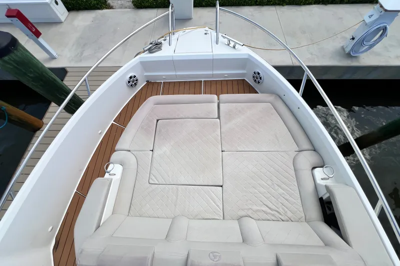 Slide: The Image of 2024 Skamander 100 Sorrento boat with cushioned seating and teak deck at dock. - 105