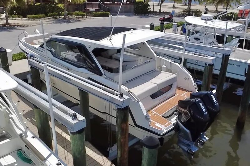 Slide: The Image of 2024 Skamander 100 Sorrento boat docked with dual outboard engines. - 3