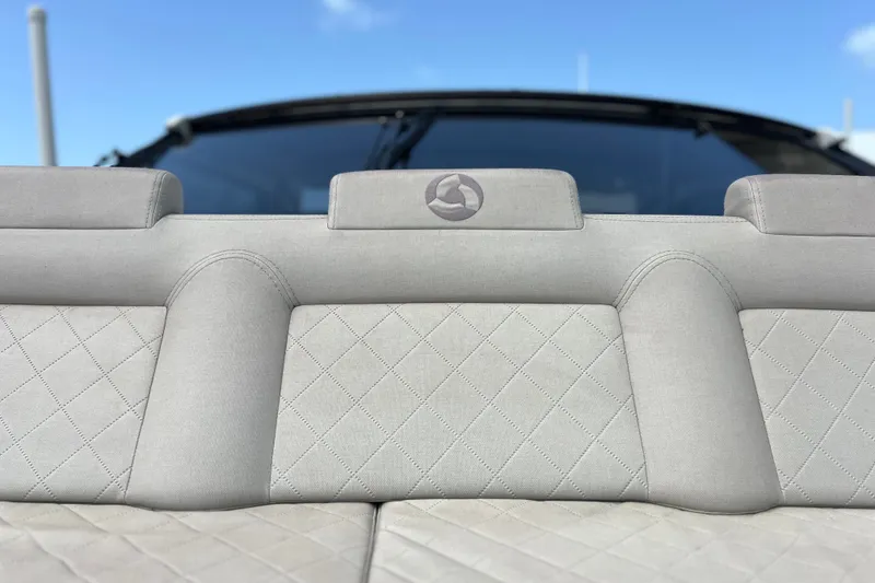 Slide: The Image of 2024 Skamander 100 Sorrento boat interior with quilted upholstery and logo detail. - 109