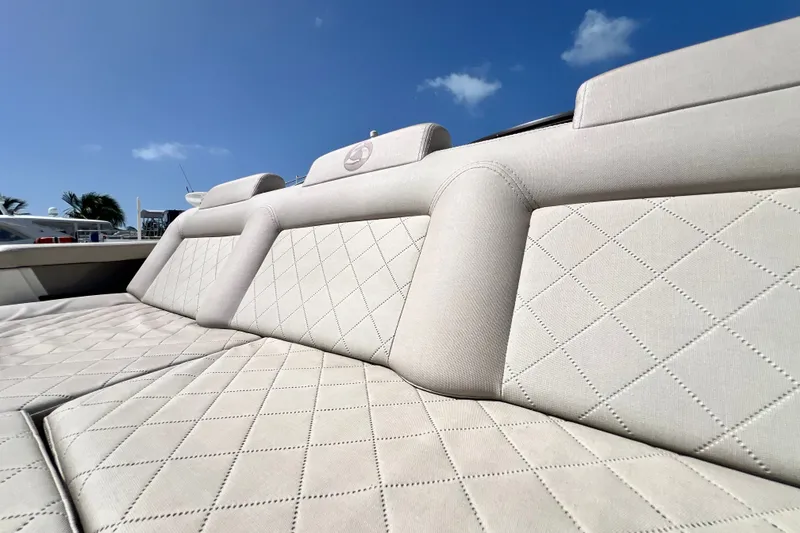 Slide: The Image of Luxurious beige seating on 2024 Skamander 100 Sorrento boat under clear blue sky. - 90