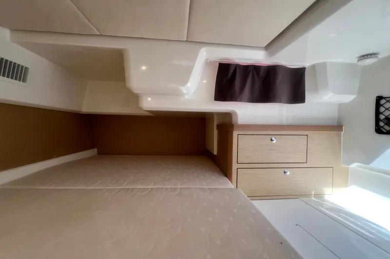 Slide: The Image of Interior cabin of 2024 Skamander 100 Sorrento boat with bed and storage drawers. - 187