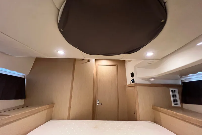 Slide: The Image of 2024 Skamander 100 Sorrento interior cabin with modern wood finish and ambient lighting. - 146