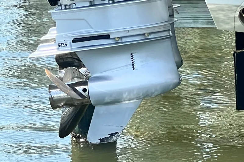 Slide: The Image of 2024 Skamander 100 Sorrento boat motor in water, showcasing propeller and lower unit. - 24