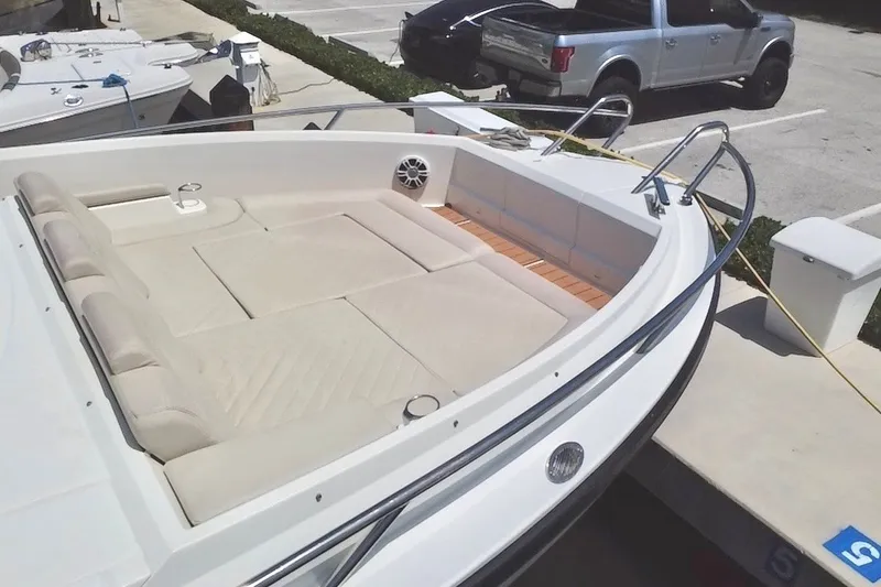 Slide: The Image of 2024 Skamander 100 Sorrento boat with spacious seating and sleek design at a dock. - 31