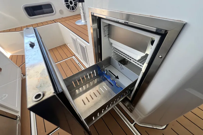 Slide: The Image of Open stainless steel drawer on 2024 Skamander 100 Sorrento yacht, showcasing interior storage. - 170