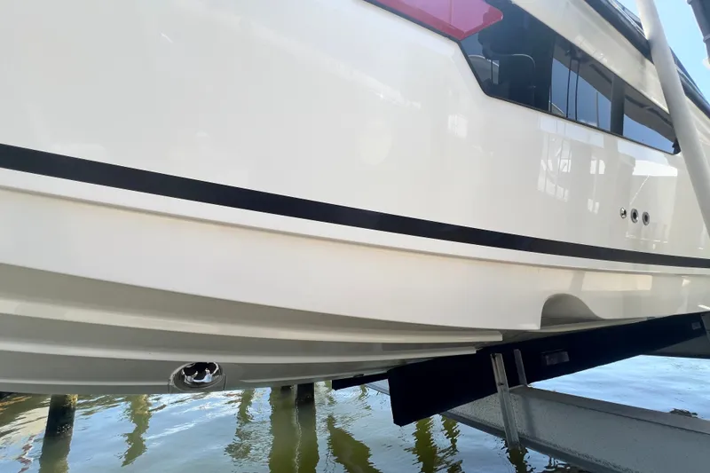 Slide: The Image of 2024 Skamander 100 Sorrento boat hull on water, showcasing sleek design and modern features. - 53