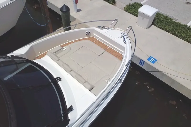 Slide: The Image of 2024 Skamander 100 Sorrento boat docked, featuring spacious seating and sleek design. - 15
