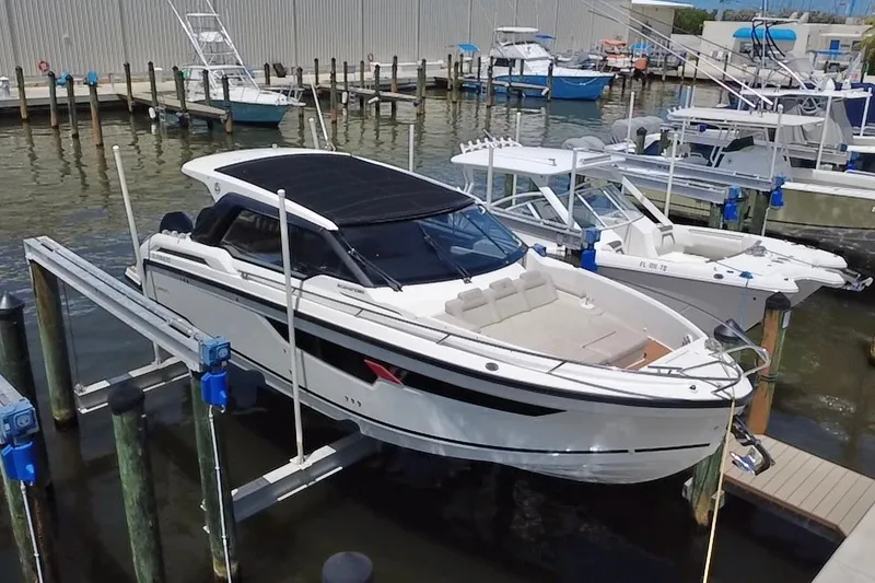 Slide: The Image of 2024 Skamander 100 Sorrento boat docked at marina, featuring sleek design and modern amenities. - 8