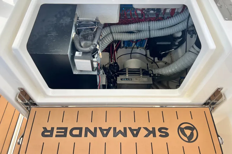 Slide: The Image of Engine compartment of 2024 Skamander 100 Sorrento boat, showcasing mechanical components. - 120