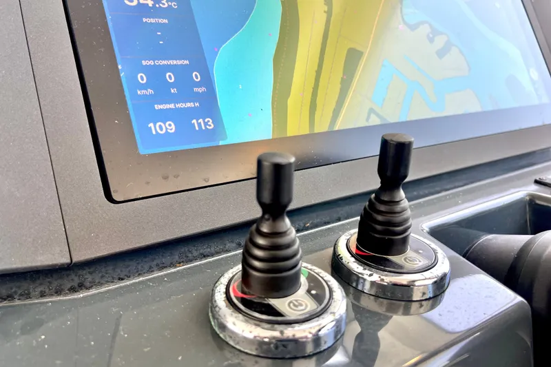 Slide: The Image of Control panel of 2024 Skamander 100 Sorrento boat with navigation display and joysticks. - 112