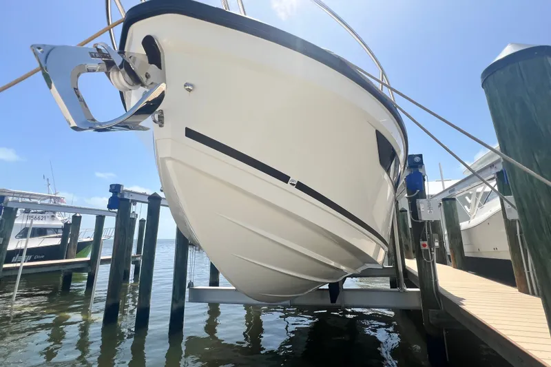 Slide: The Image of 2024 Skamander 100 Sorrento yacht docked, showcasing sleek hull design and anchor. - 40