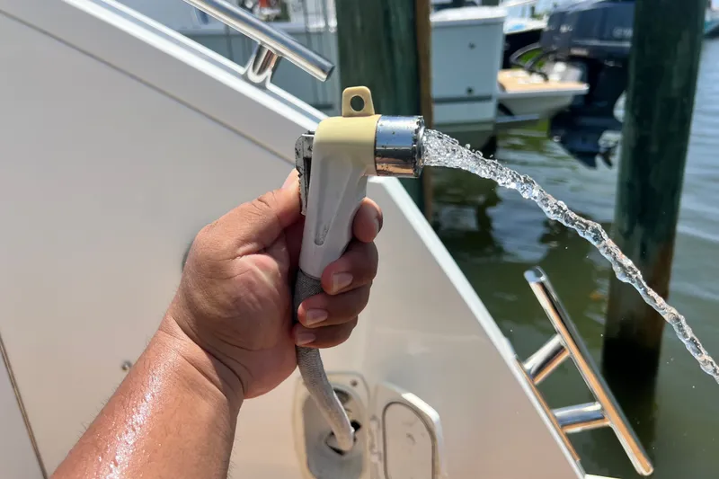 Slide: The Image of Hand holding a boat hose sprayer on a 2024 Skamander 100 Sorrento yacht. - 79
